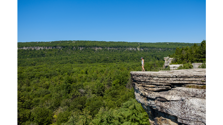 Hiker standing at the edge of the cliff