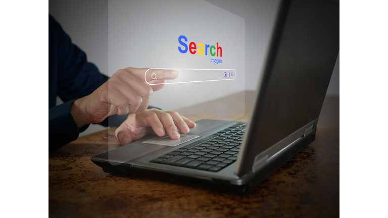 A man is using a notebook computer to searching for information. A virtual screen of the Search website browser for finding data on the internet. Global network, search engine optimization technology