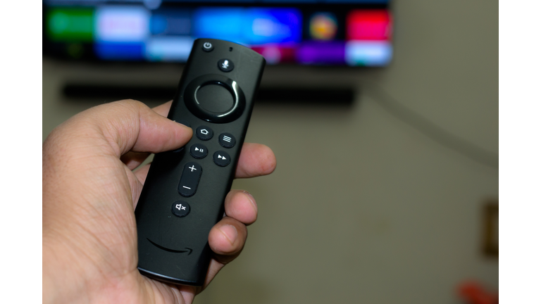 Amazon fire stick TV remote in hand