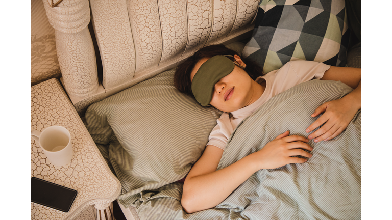 asian woman sleeping on bed in the morning