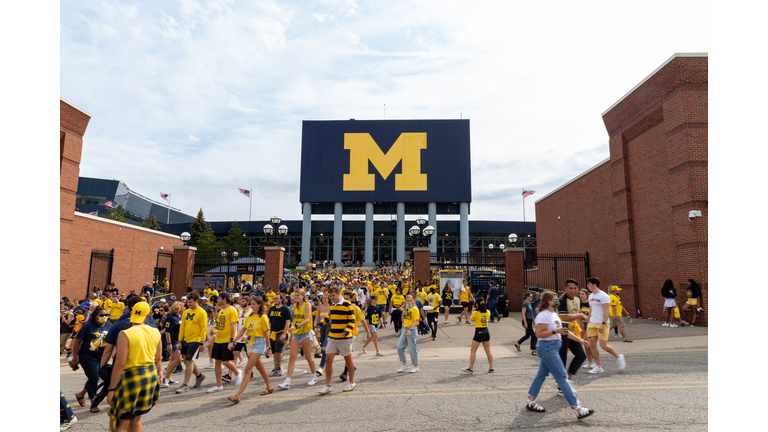 Unidentified Fans exit Michigan Stadium after a University of Michigan football game