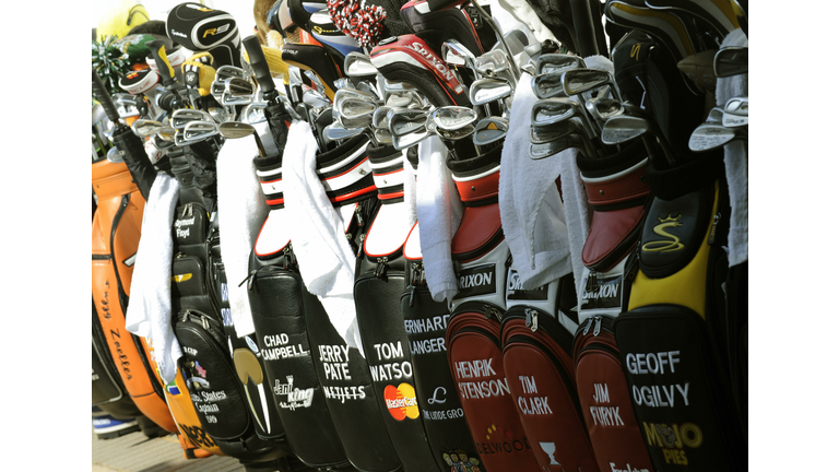 Golf bags are lined up in the caddyshack