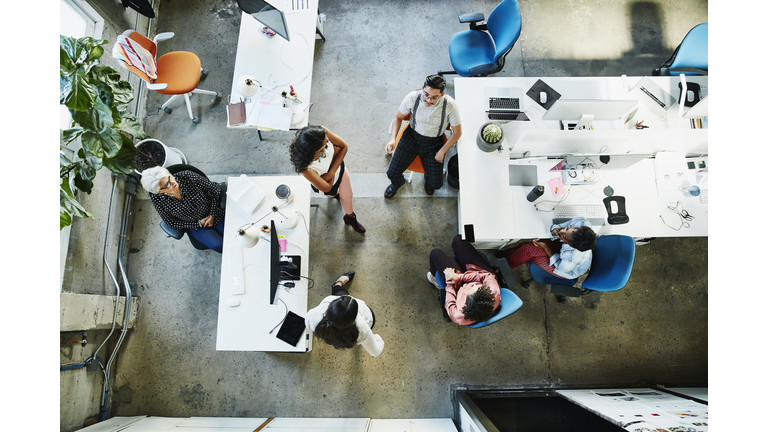 Overhead view of design team having project meeting in office