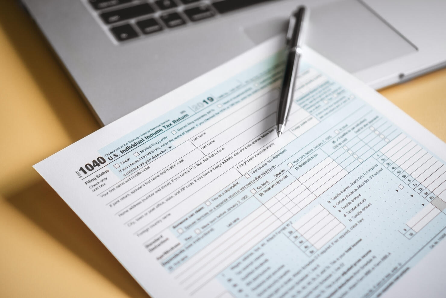 Close Up of Tax Form and Laptop on Work Desk