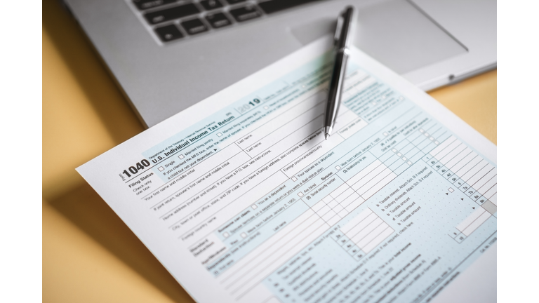 Close Up of Tax Form and Laptop on Work Desk