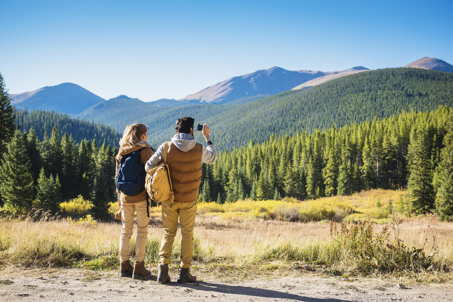 Hispanic couple photographing mountains, Breckenridge, Colorado, United States, 