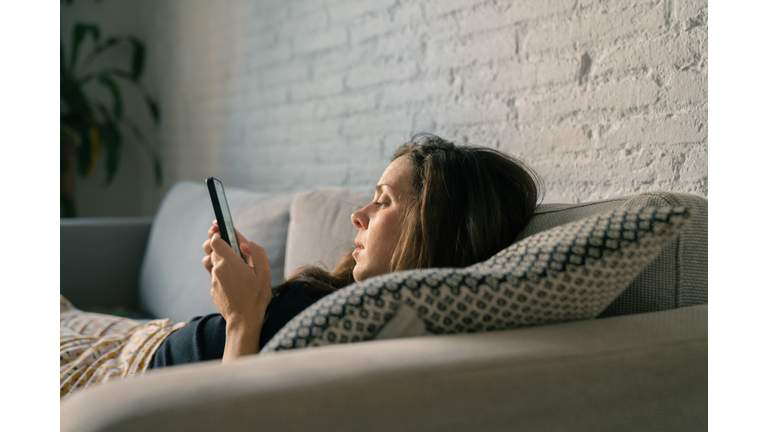 Sad woman using cellphone