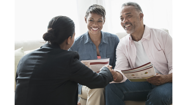 African American couple talking to businesswoman