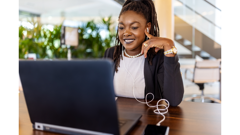 Entrepreneur having online teleconference meeting on her laptop