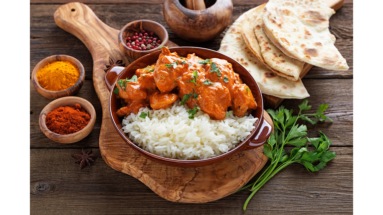 Chicken tikka masala spicy curry meat food in a clay plate with rice