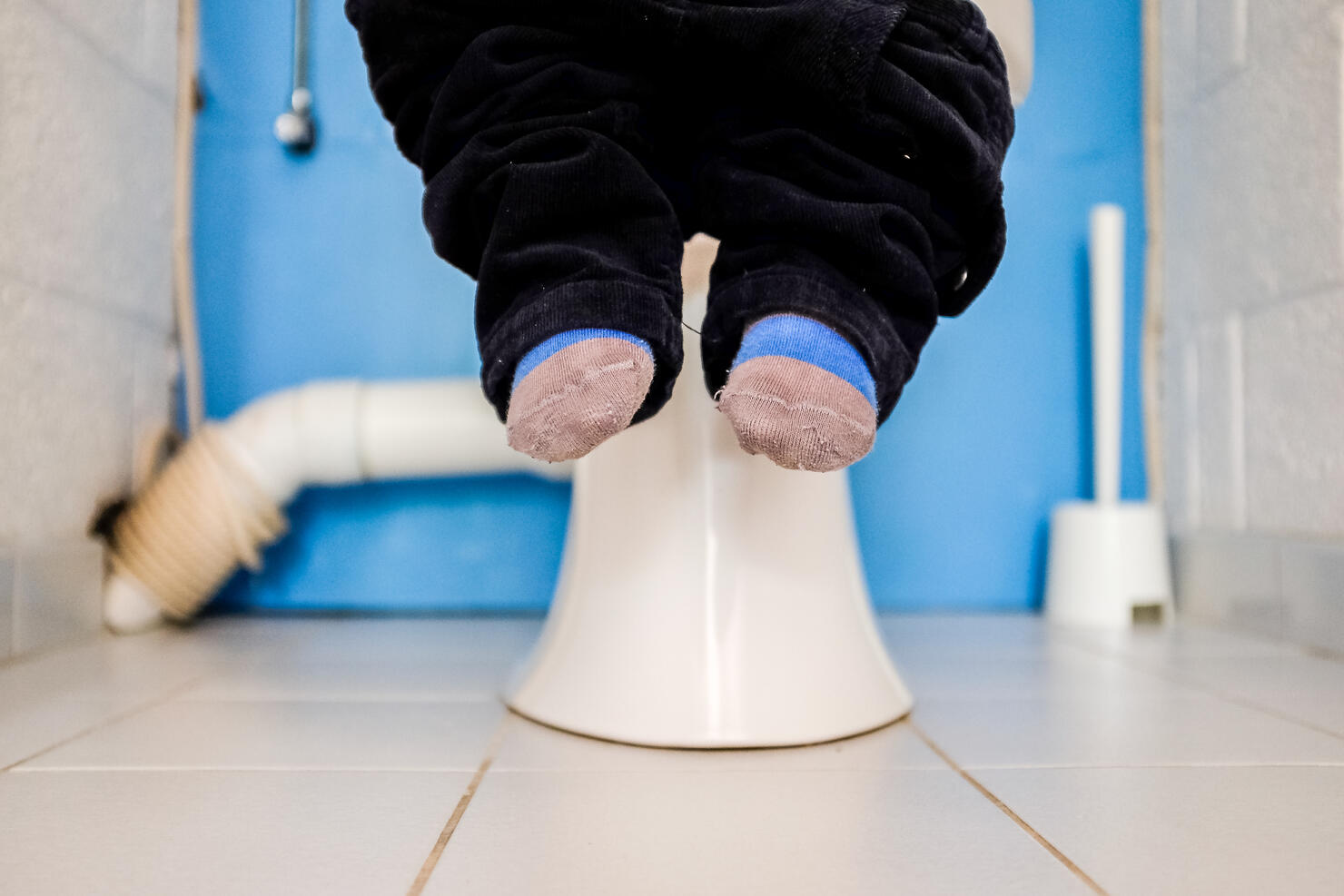 Young boy sitting on toilet