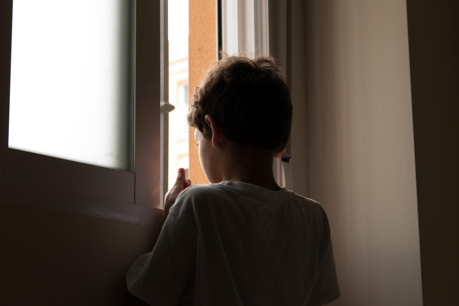 teenage looking out window