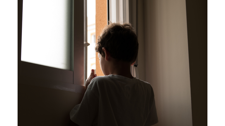 teenage looking out window