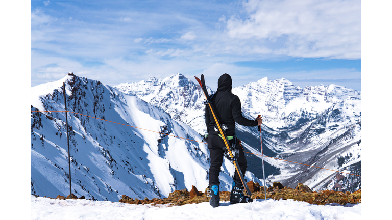 Man With Skis At Summit Extreme Ski Concept