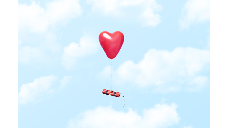 Heart shaped balloon carrying a dynamite stick