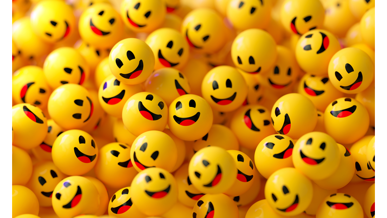 Yellow Spheres Textured With Happy Face Emoji On Yellow Background
