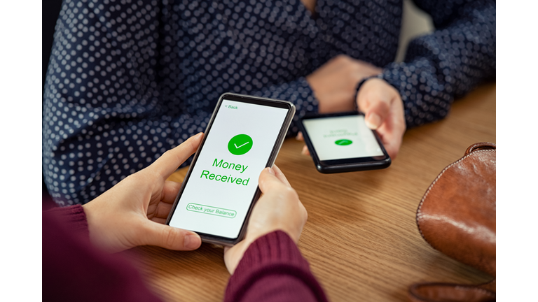 Woman receiving digital money using phone