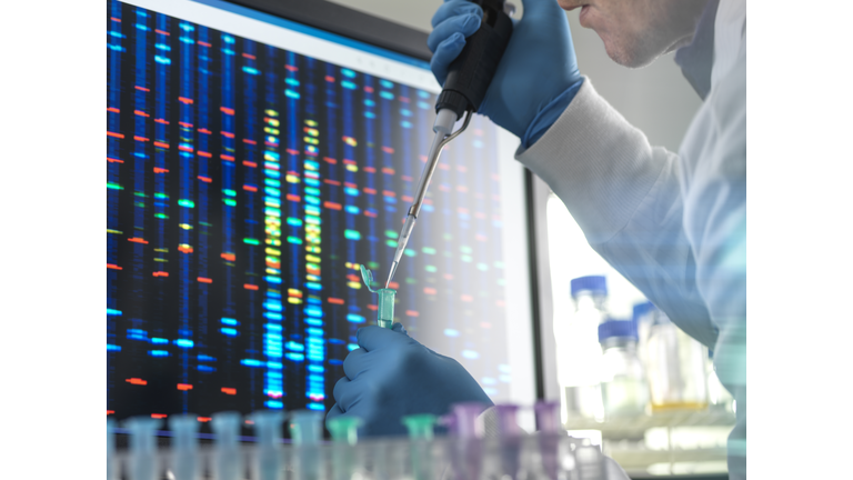 Scientist pipetting a DNA sample into a vial ready for testing