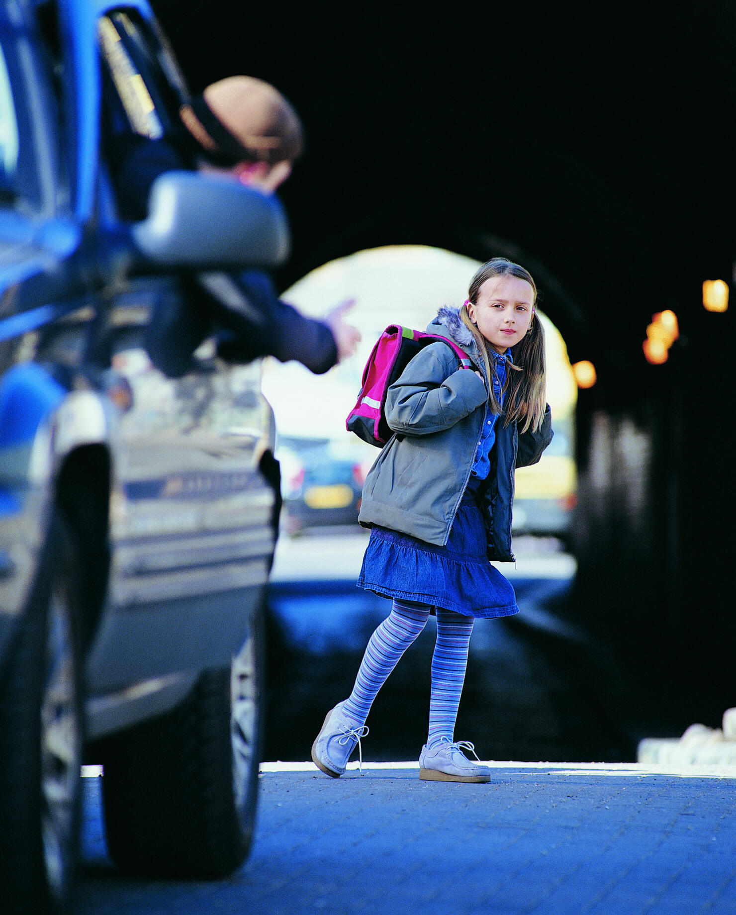Man in a Car Beckoning an Apprehensive Girl Standing in a City Street