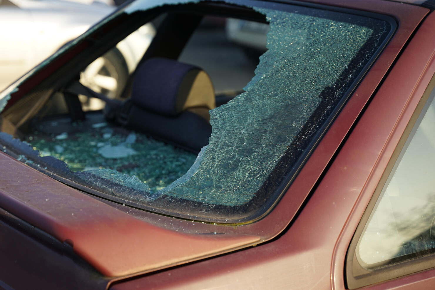 Somebody vandalized rear window in car, thief smashed window and stole valuable items concept