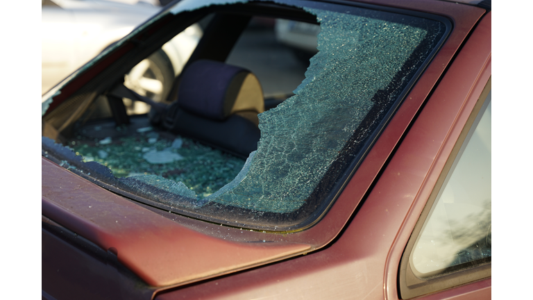 Somebody vandalized rear window in car, thief smashed window and stole valuable items concept