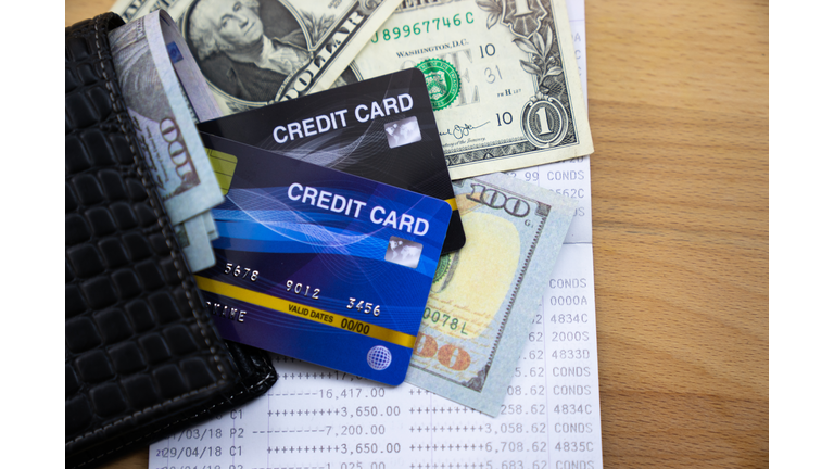 Wallet with credit cards in bills and account books.