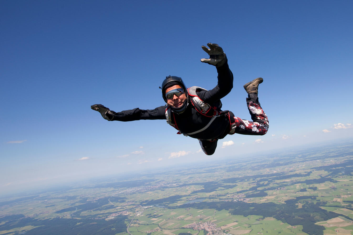 Man skydiving over rural landscape