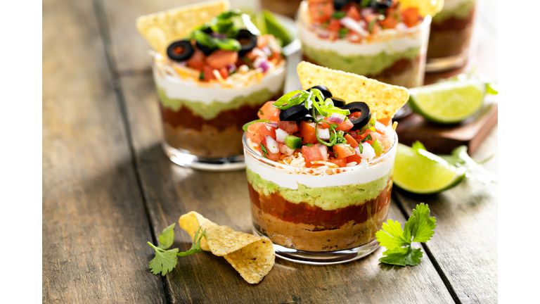 Seven layer dip in individual cups, mexican appetizer