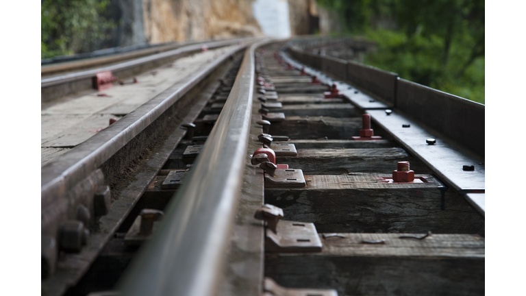 Close-up of rail tracks on wooden trestle viaduct of Trans-River Kwai Death Railway at Saphan Tham Krasae, near Kanchanaburi.