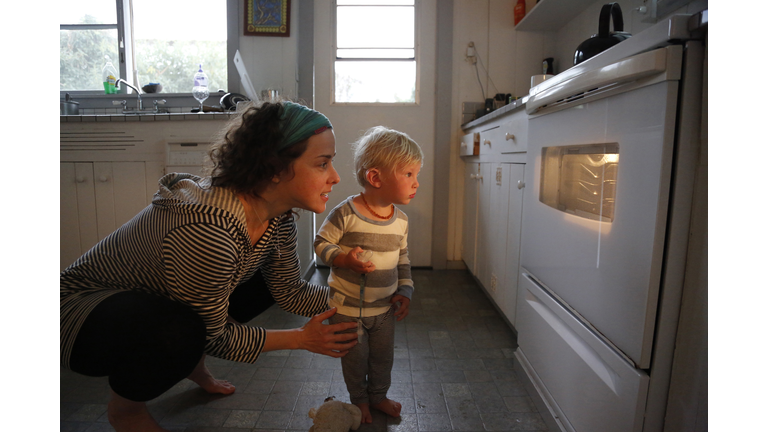 Mother and son looking in oven window