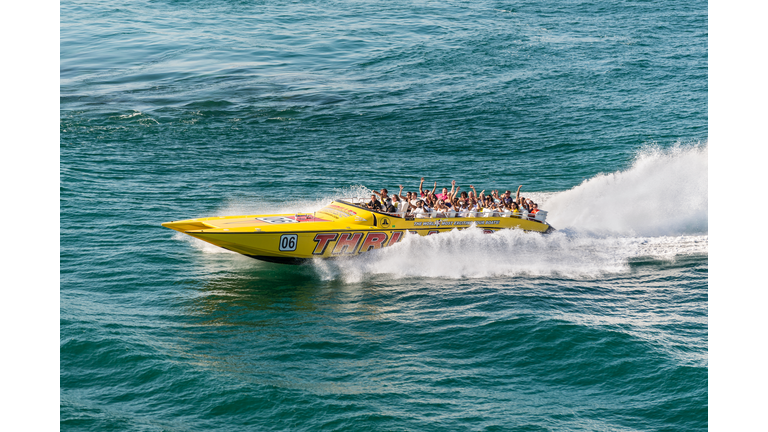 Tourists enjoying a high speed sightseeing boat tour of Miami and Miami Beach