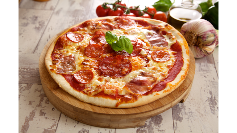 Pizza with sprig of basil