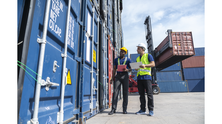 Multi-ethnic men working at shipping port