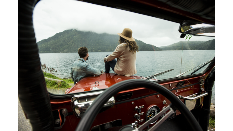 A couple in a convertible.