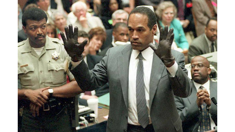 O.J. Simpson shows the jury a new pair of Aris ext