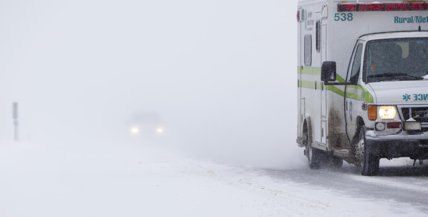 Ambulance on the road in Snowstorm