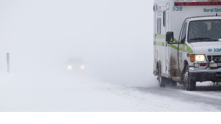 Ambulance on the road in Snowstorm