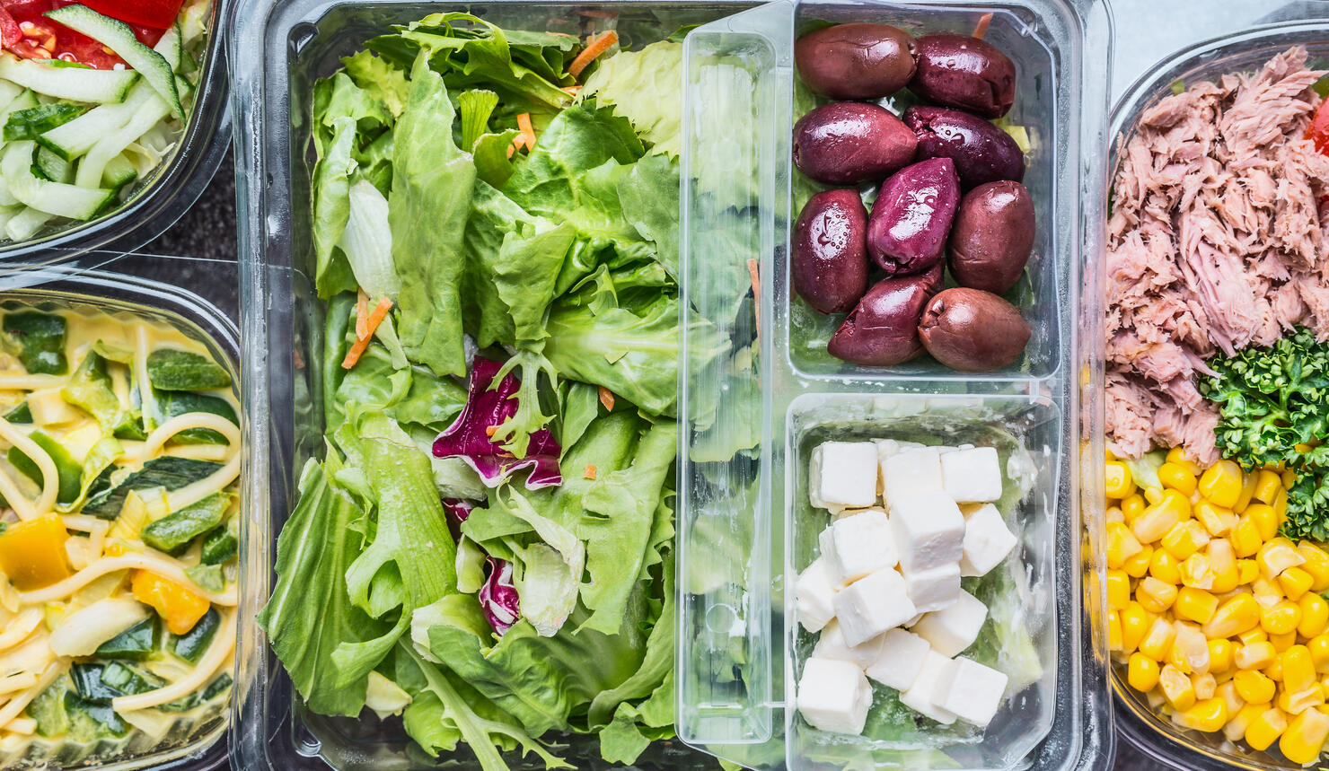Close up of Various Healthy vegetables salad lunch boxes in plastic packages, top view