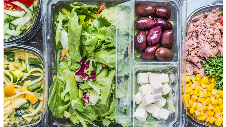 Close up of Various Healthy vegetables salad lunch boxes in plastic packages, top view
