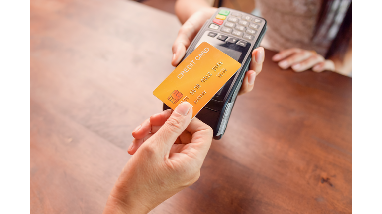 Person paying with a credit card using a credit card terminal