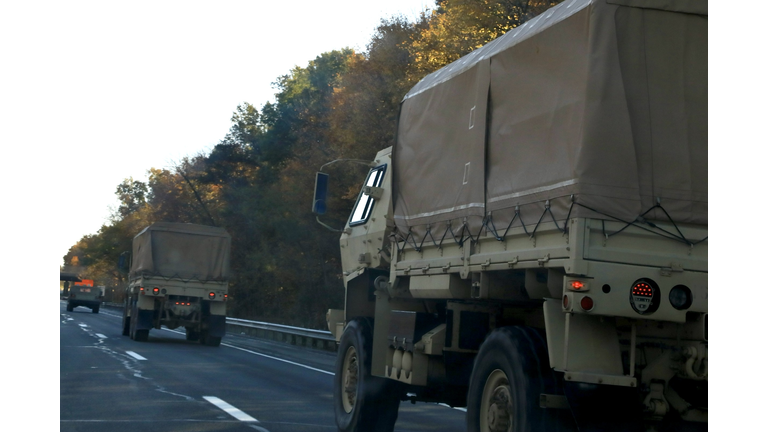 Military vehicle convoy on a highway