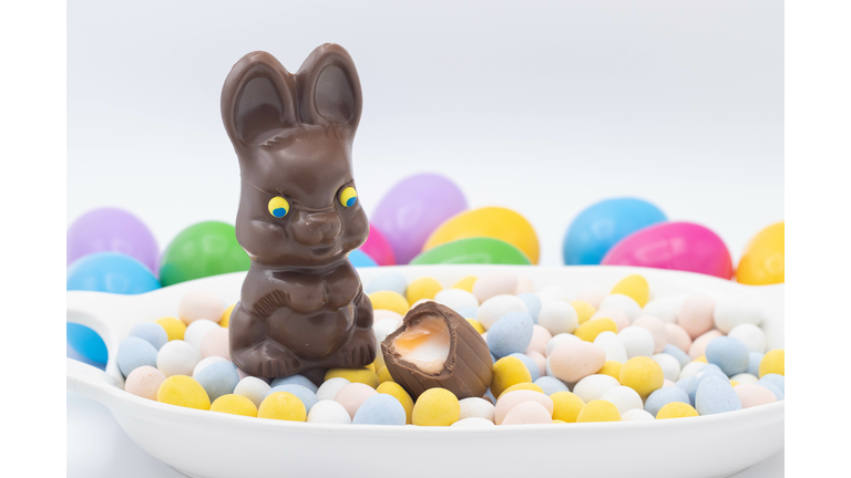 Chocolate bunny with cadbury creme egg on top of candy eggs