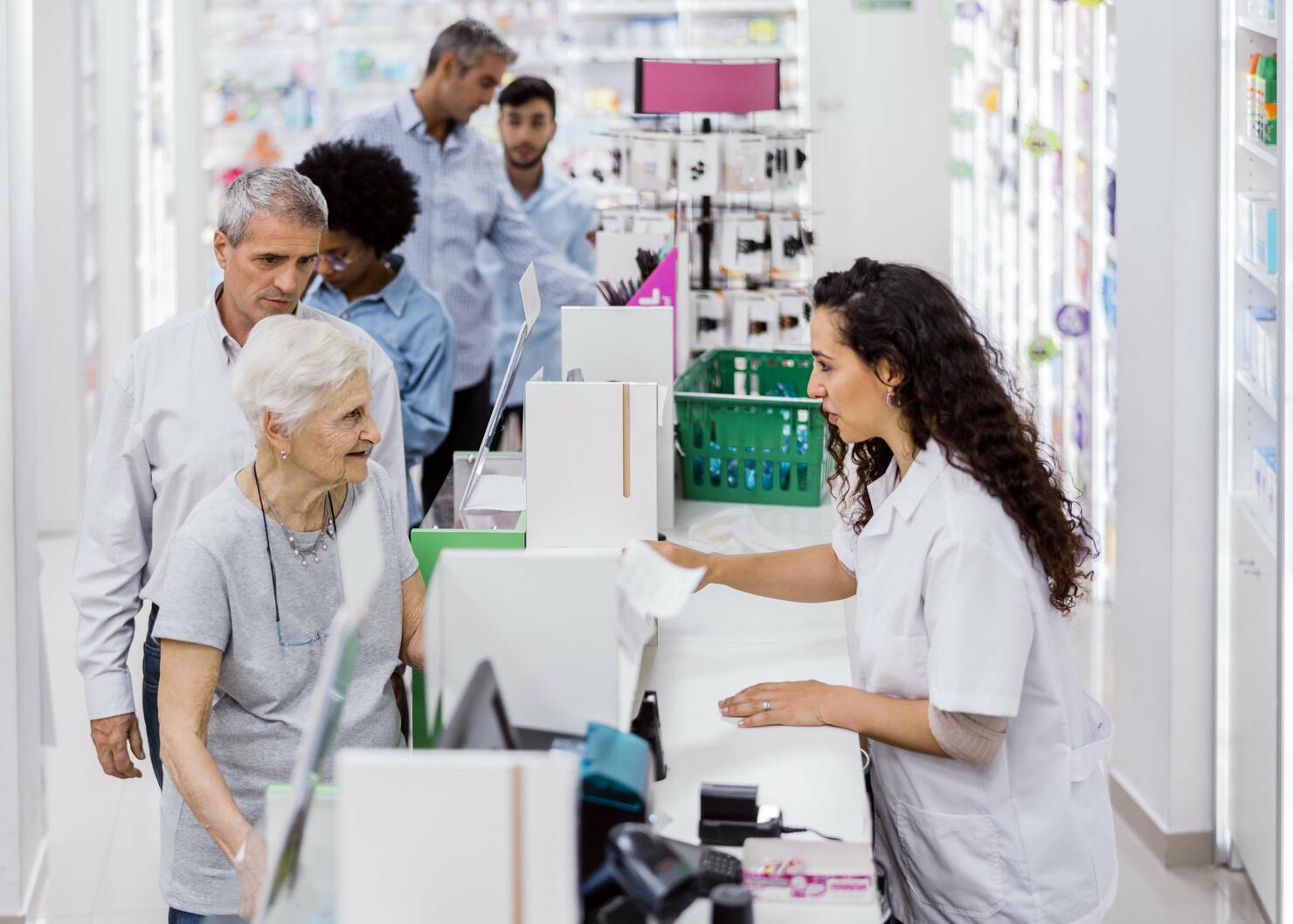 Customers and chemist in drugstore