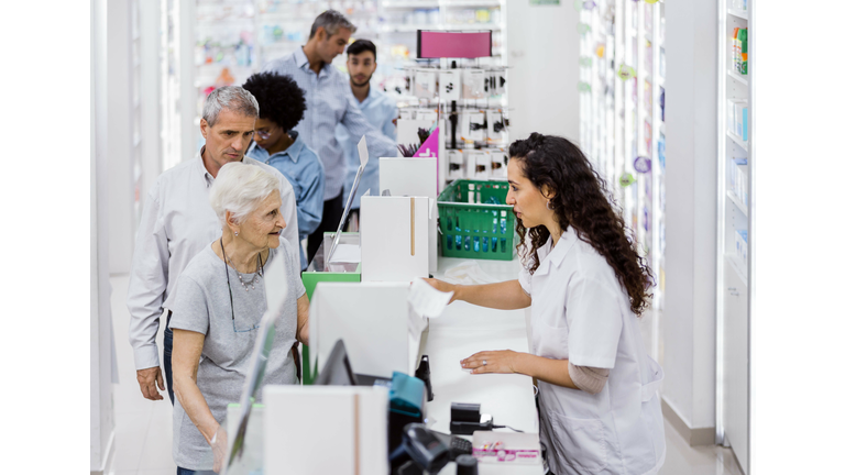 Customers and chemist in drugstore