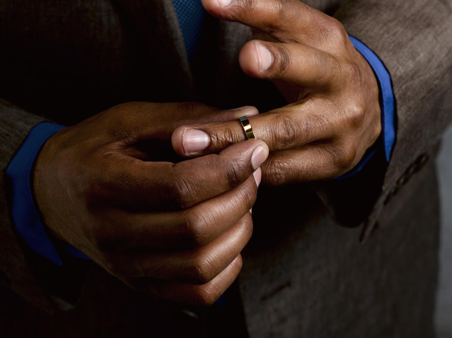 Business man putting on wedding band