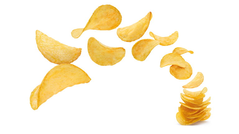 Delicious potato chips on white