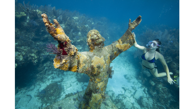 Snorkeler with Bronze Statue of Christ.