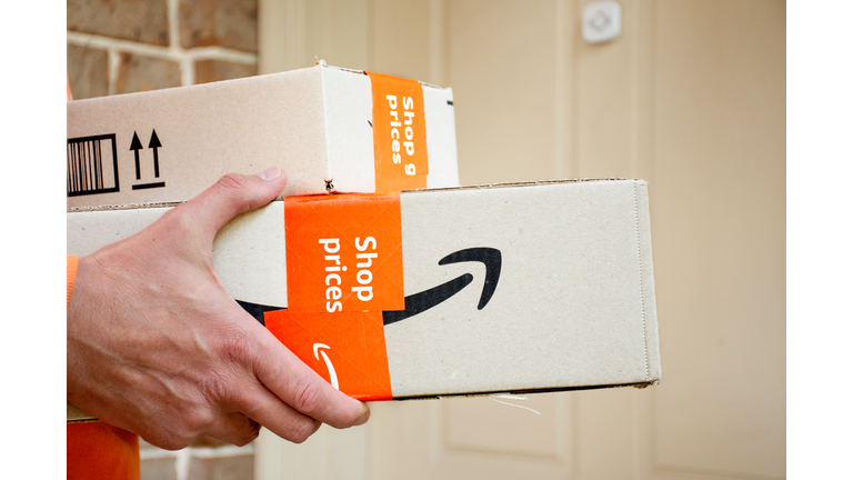 Amazon prime boxes delivered to a front door of residential building.