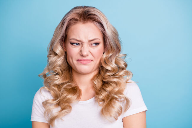 Close up photo beautiful her she lady awful awkward situation look hate mad rage outraged ugh facial expression wear casual white t-shirt jeans denim clothes outfit isolated bright blue background