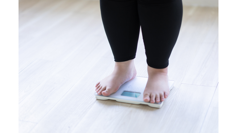 A woman's feet on a weight scale